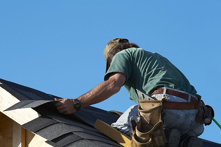 man fixing roof